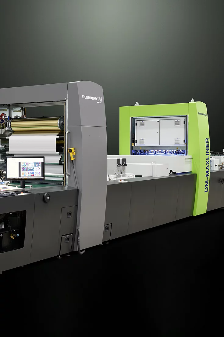 Kurz Digital Embellishement Solution with gray and green components labeled "STEINEMANN DPE" and "DM-MAXLINER," used for high-speed spot coating and metallization.