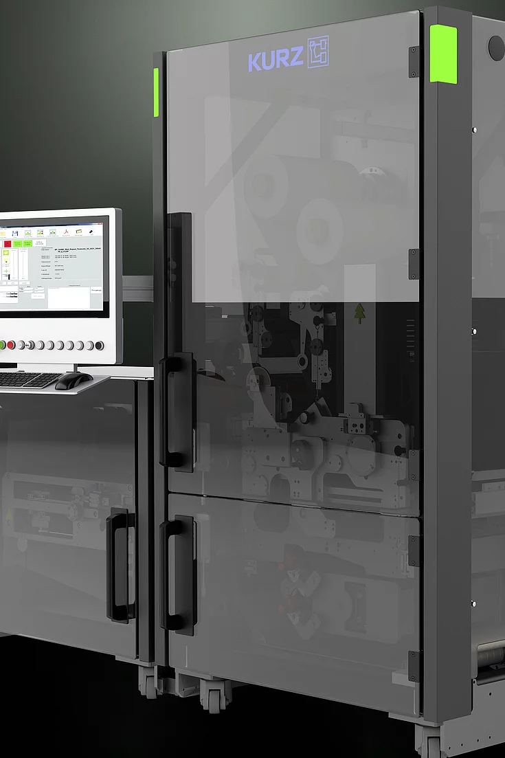Close-up of a modern industrial machine with a transparent door and control panel.